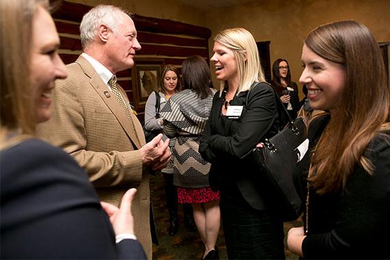 Students networking with alumni at mixer